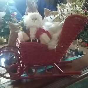 Christmas Santa and a wicker sleigh and two reindeer A star